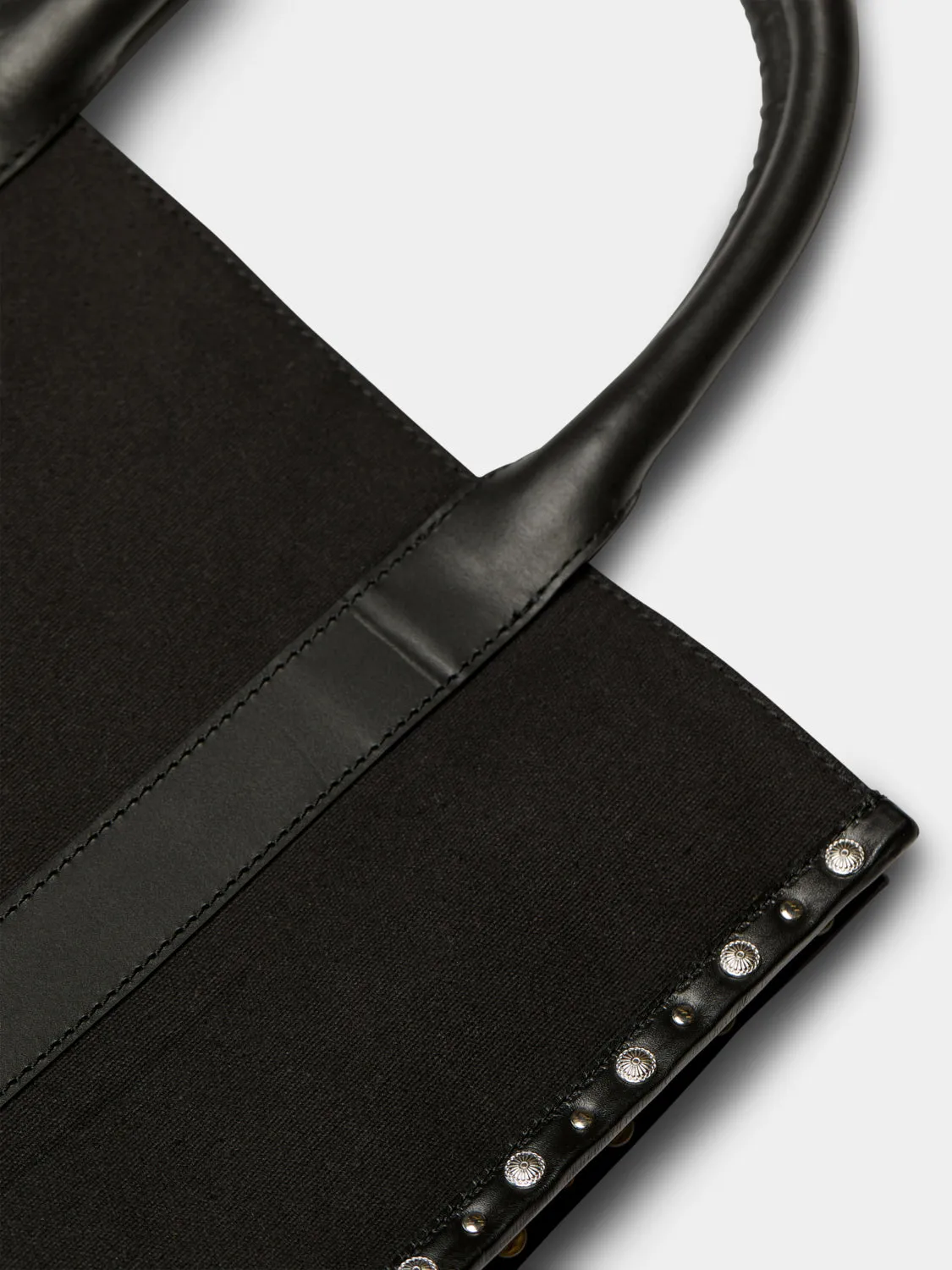 Canvas shopper with studs and leather trimming